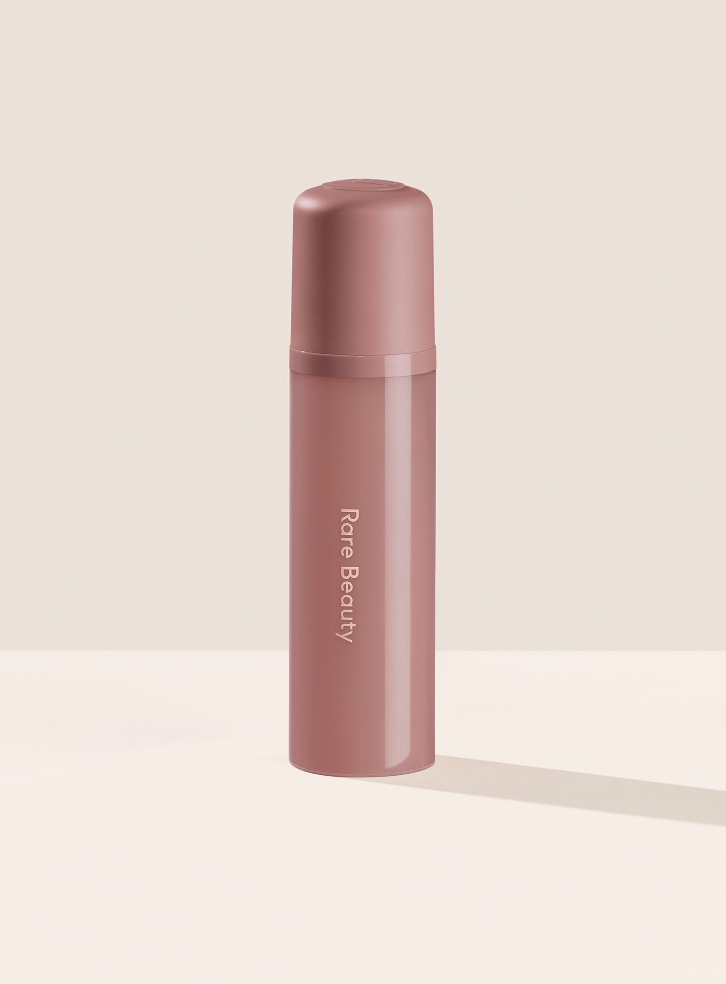 Rare Beauty's Find Comfort Body & Hair Fragrance Mist standing on a white table against a white background.