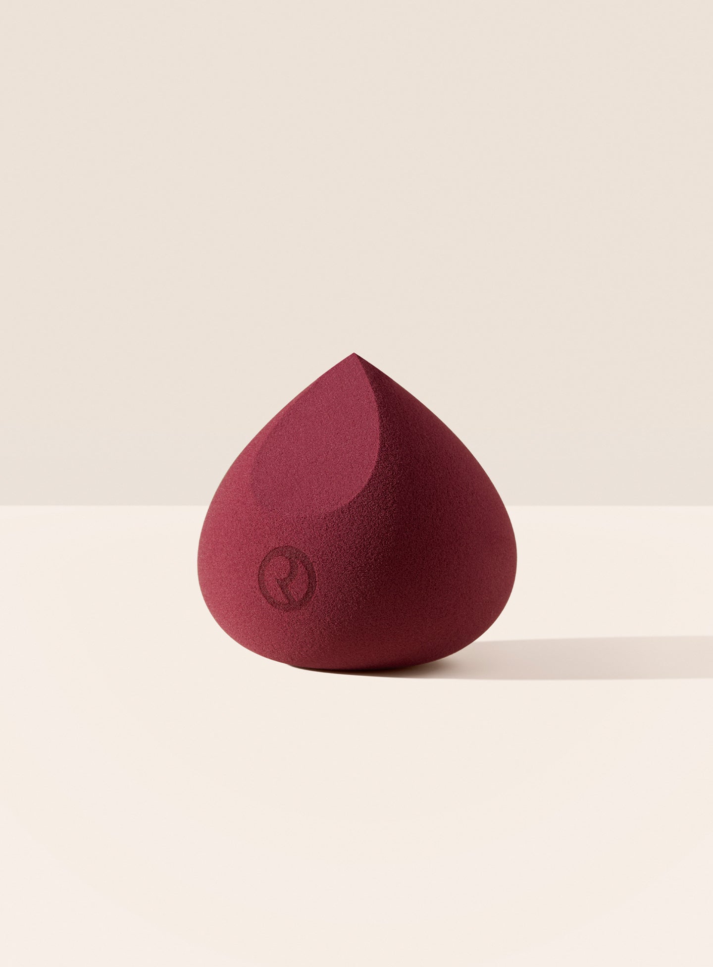 Rare Beauty maroon beauty blender, a multiuse sponge for liquid, cream, and loose powder