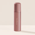 Rare Beauty's Find Comfort Body & Hair Fragrance Mist standing on a white table against a white background.