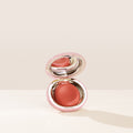 Shade Nearly Apricot, in a muted coral, of Rare Beauty's Stay Vulnerable Melting Blush.